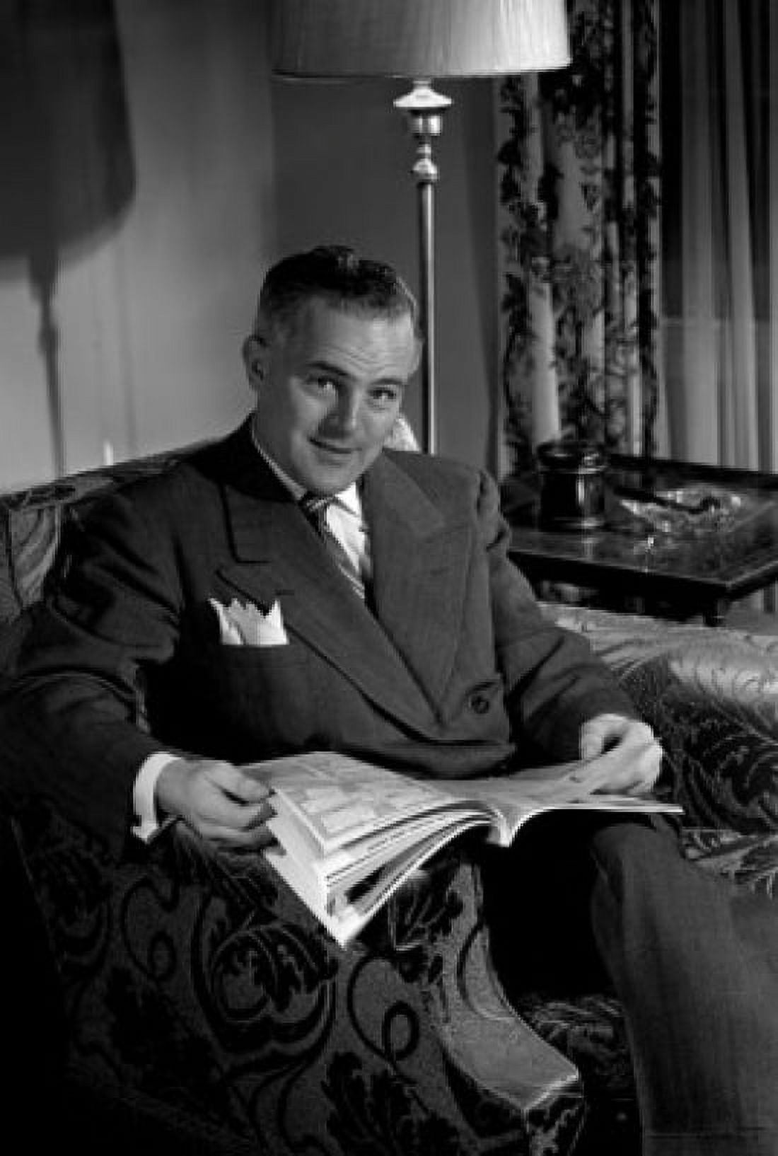 Posterazzi Portrait of mature man sitting in armchair browsing comic Canvas Art - (24 x 36)