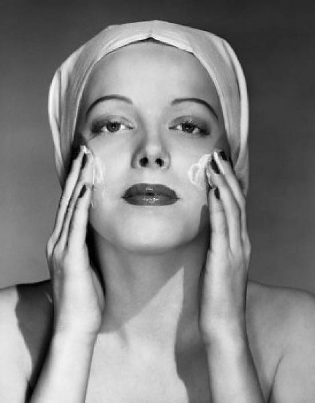 Posterazzi Portrait of young woman applying cream to her face Canvas Art - (24 x 36)
