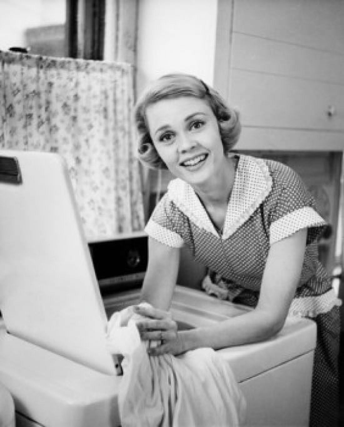 Posterazzi Portrait of young woman leaning on washing machine Canvas Art - (24 x 36)