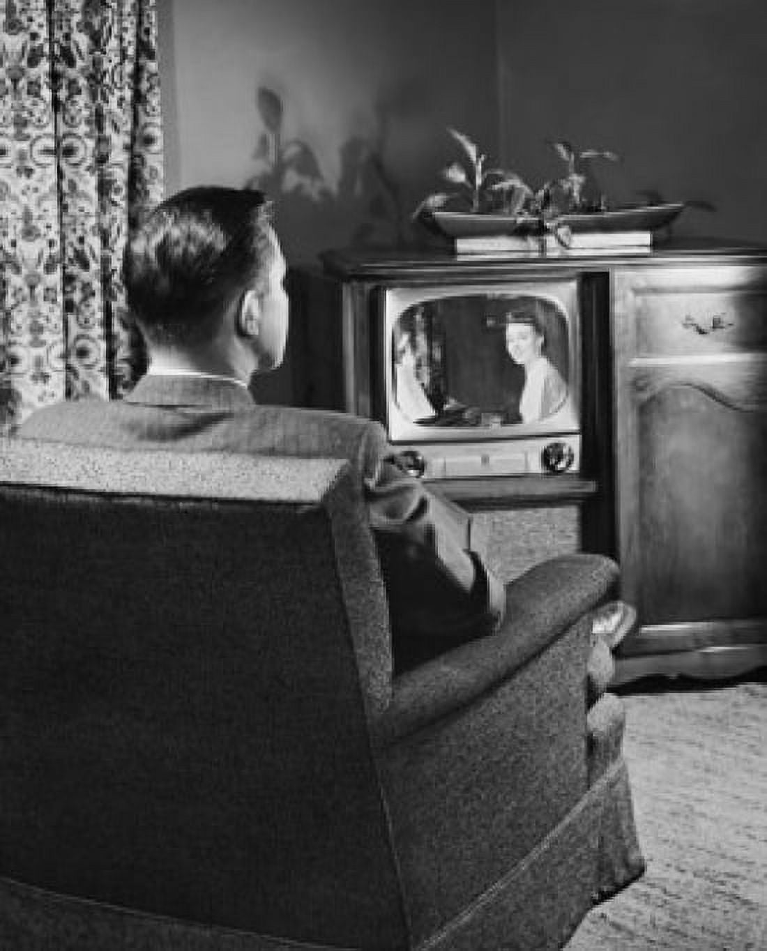 Posterazzi Rear view of a mid adult man watching television Canvas Art -  (24 x 36)