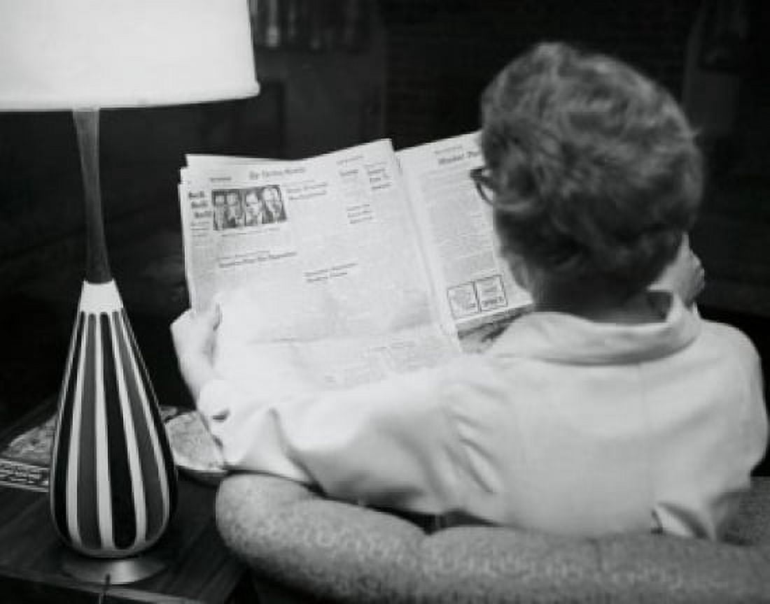 Posterazzi Rear view of a young woman reading a newspaper Canvas Art -  (24 x 36)