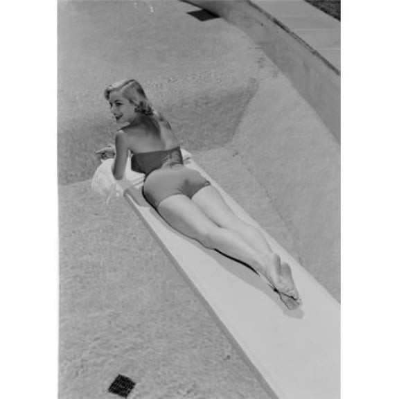 Posterazzi SAL255419031 Young Woman in Swimwear Lying on Diving Board Poster Print - 18 x 24 in.