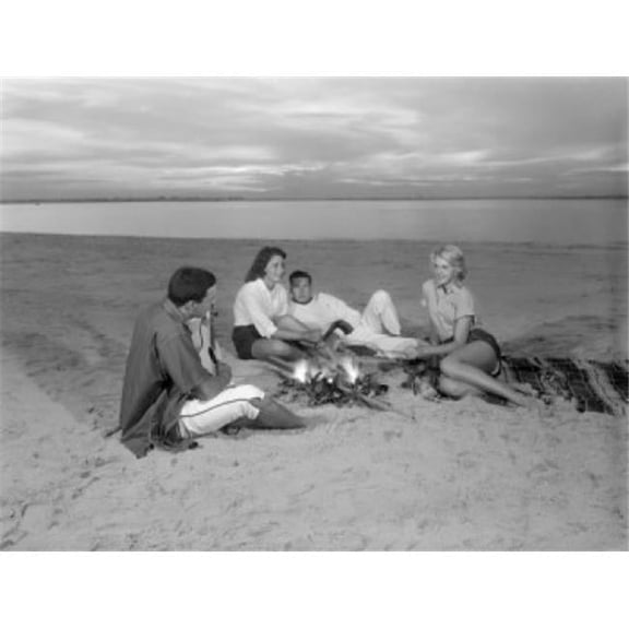 Posterazzi SAL255421961 Group of Young Friends Resting by Bone Fire on Sandy Beach Poster Print - 18 x 24 in.