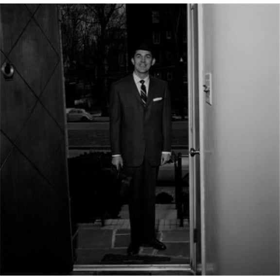 Posterazzi SAL255422666 Man Wearing Suit Standing in Doorway of House Poster Print - 18 x 24 in.