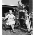 thumbnail image 1 of Posterazzi SAL2555146 Mid Adult Couple with Golf Clubs Holding Drinks Poster Print - 18 x 24 in., 1 of 1