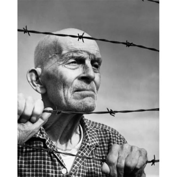 Posterazzi SAL2555310 Close-Up of a Senior Man Looking Through Barbed Wire Fence Poster Print - 18 x 24 in.