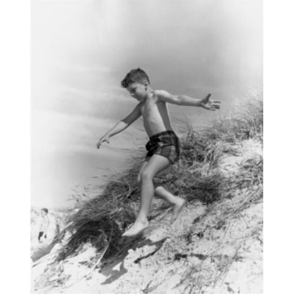 Posterazzi SAL2557750 Boy Jumping From Sand Dune Poster Print - 18 x 24 in.