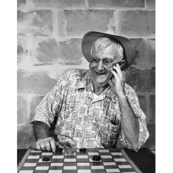 Posterazzi SAL2558046 Mature Man Playing Checkers & Smiling Poster Print - 18 x 24 in.