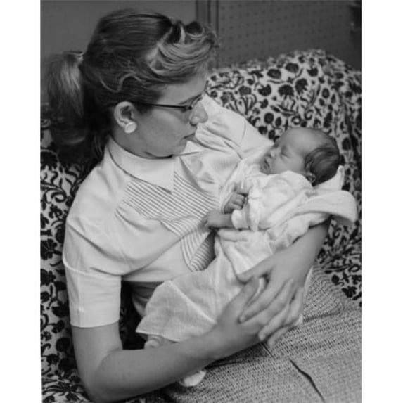 Posterazzi SAL2559811 Mother Sitting on Sofa with Sleeping Baby in Arms Poster Print - 18 x 24 in.