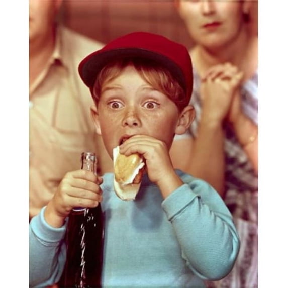 Posterazzi SAL3811361955 Close-Up of a Boy Eating a Hot Dog & Holding a Bottle of Soda Poster Print - 18 x 24 in.