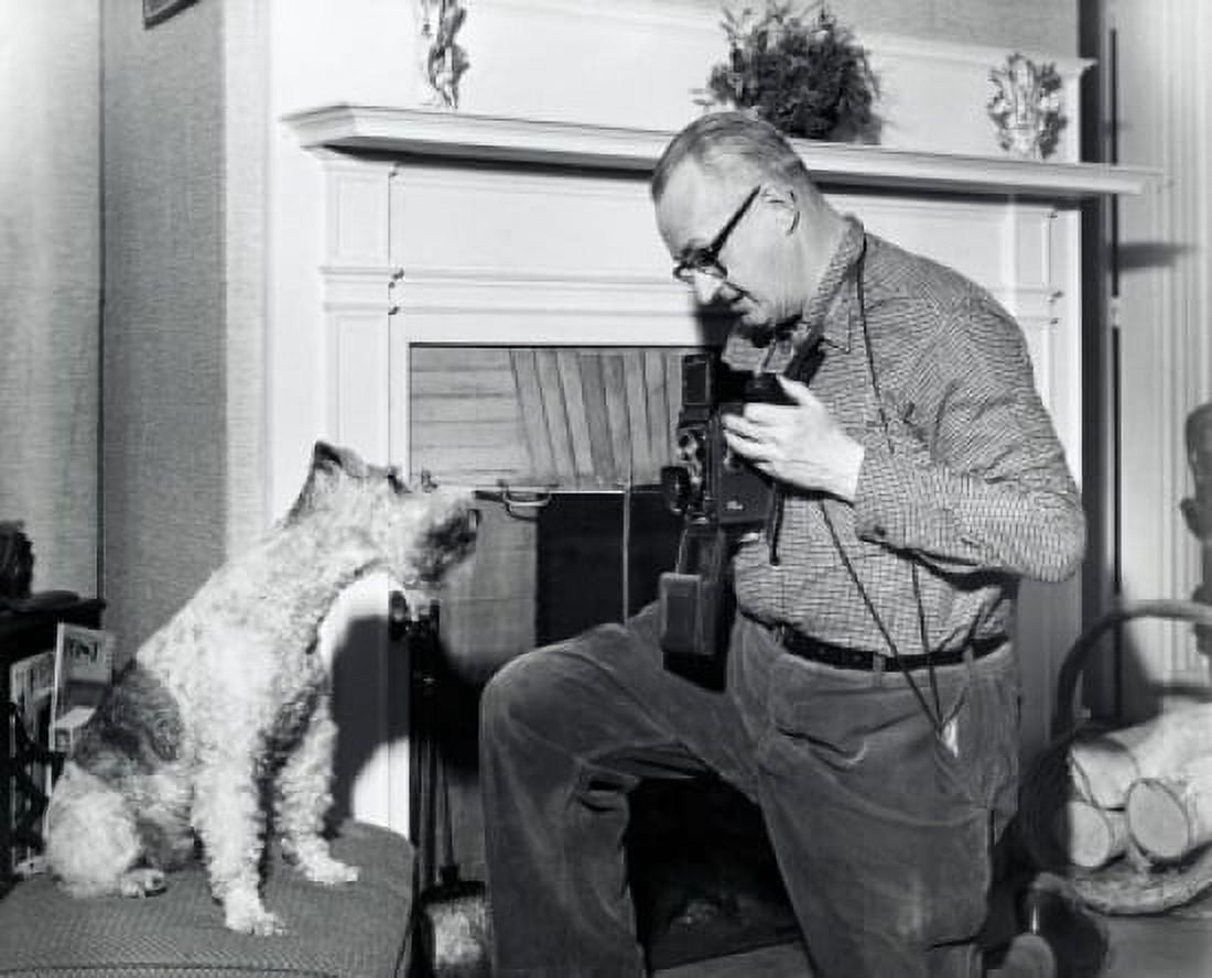 Posterazzi Senior man photographing dog in living room Canvas Art -  (24 x 36)