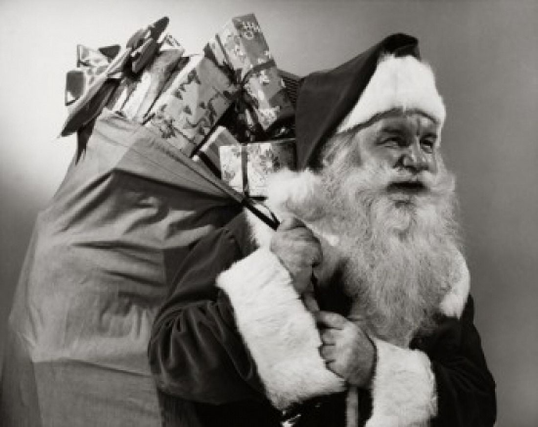 Posterazzi Side profile of Santa Claus carrying a sack of Christmas presents on his back Canvas Art -  (24 x 36)