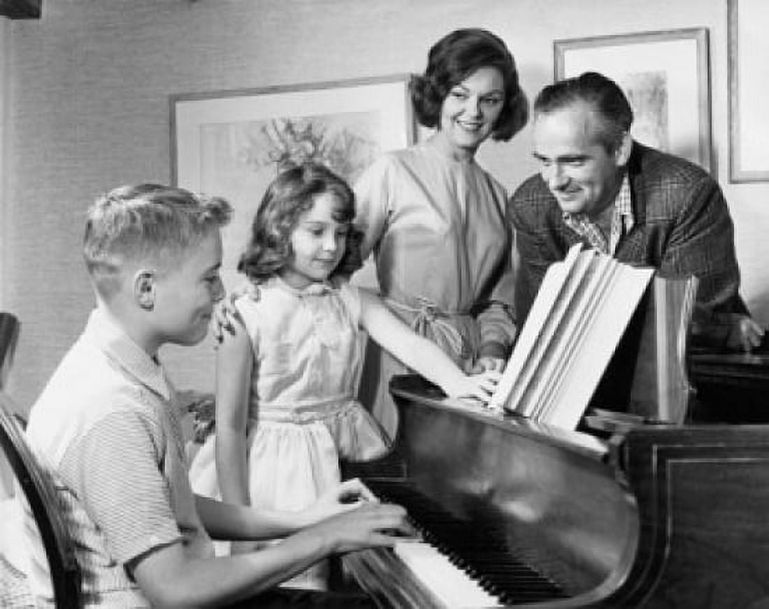 Posterazzi Side profile of a boy playing a piano with his family standing beside him Canvas Art - (24 x 36)