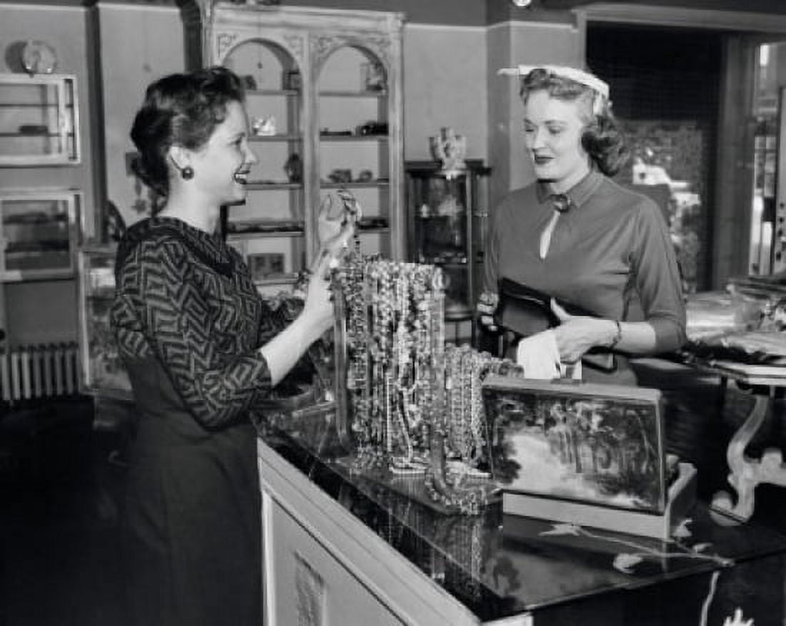 Posterazzi Side profile of a female sales clerk showing jewelry to a customer Canvas Art - (24 x 36)