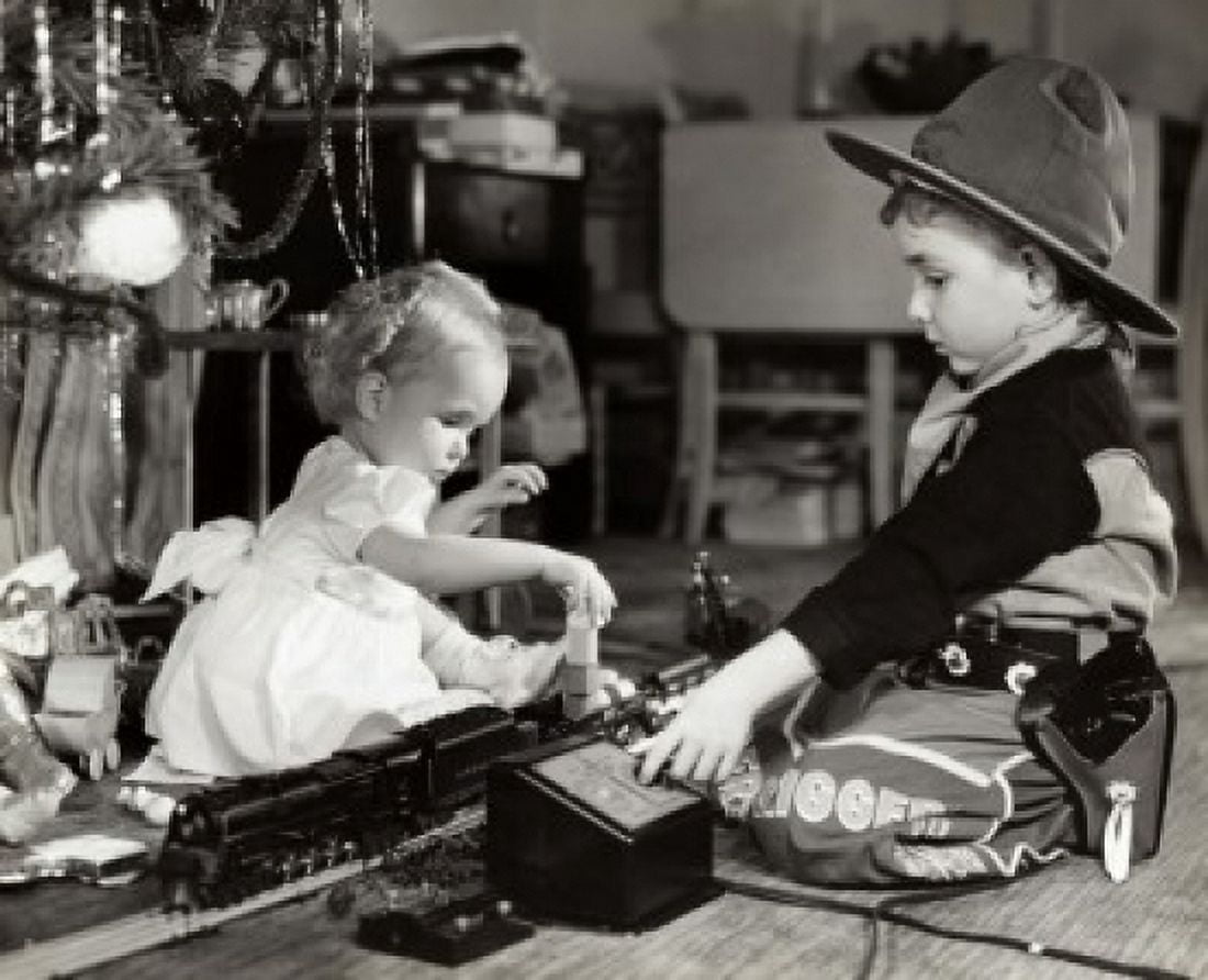 Posterazzi Side profile of a girl and her brother playing with a toy train Canvas Art - (24 x 36)