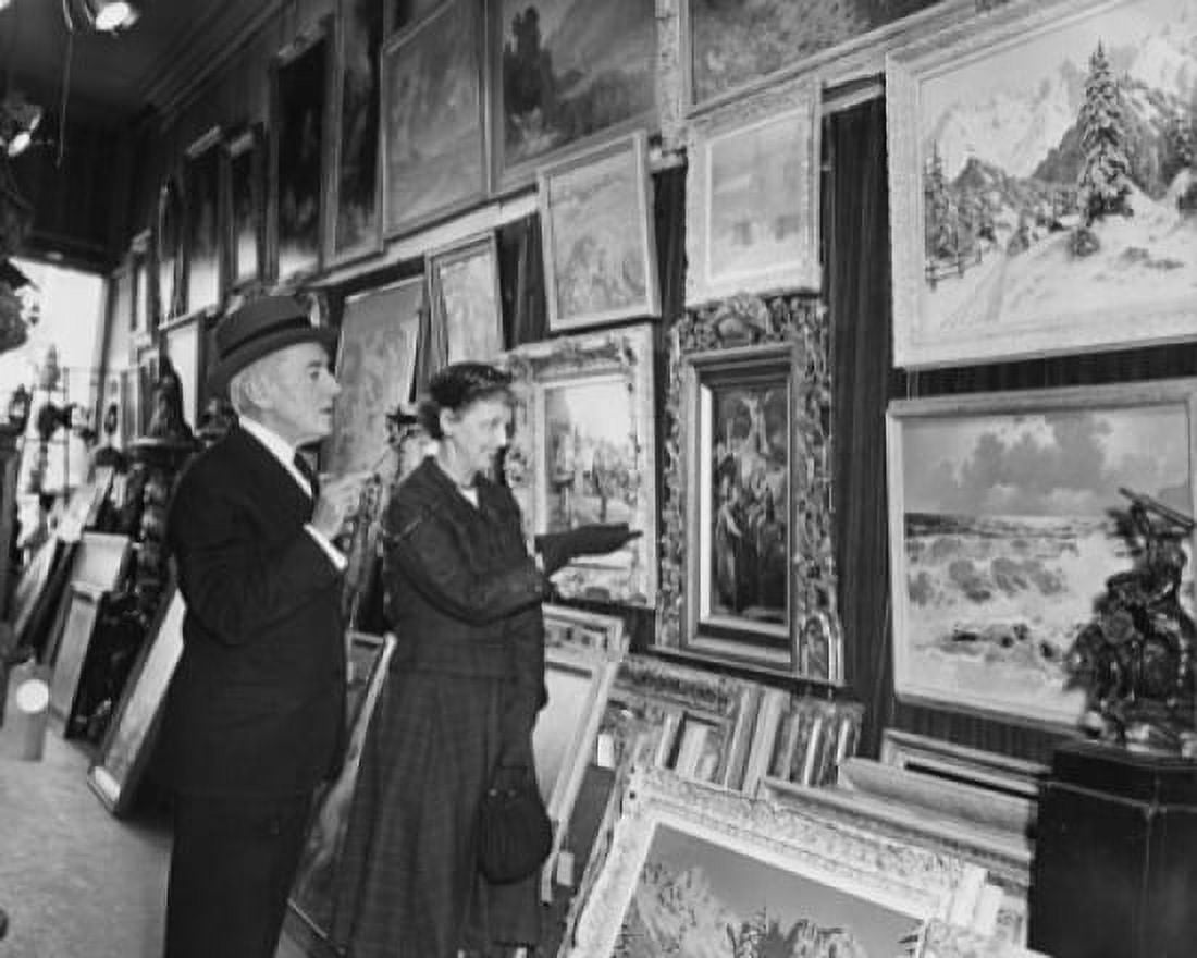 Posterazzi Side profile of a mature couple looking at paintings in a store Canvas Art - (24 x 36)