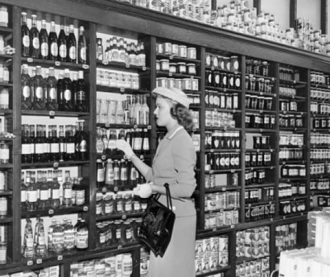 Posterazzi Side profile of a mid adult woman picking bottle from a shelf in a store Canvas Art - (24 x 36)
