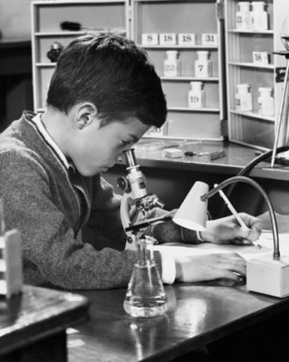 Posterazzi Side profile of a schoolboy looking through a microscope Canvas Art - (24 x 36)