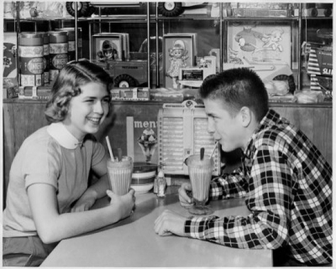 Posterazzi Side profile of a teenage couple drinking a milk shake in a restaurant Canvas Art - (24 x 36)