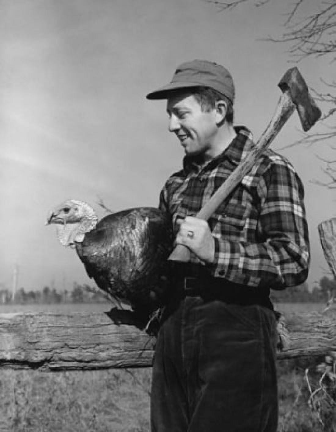 Posterazzi Side profile of a young man carrying a turkey and an axe Canvas Art - (24 x 36)
