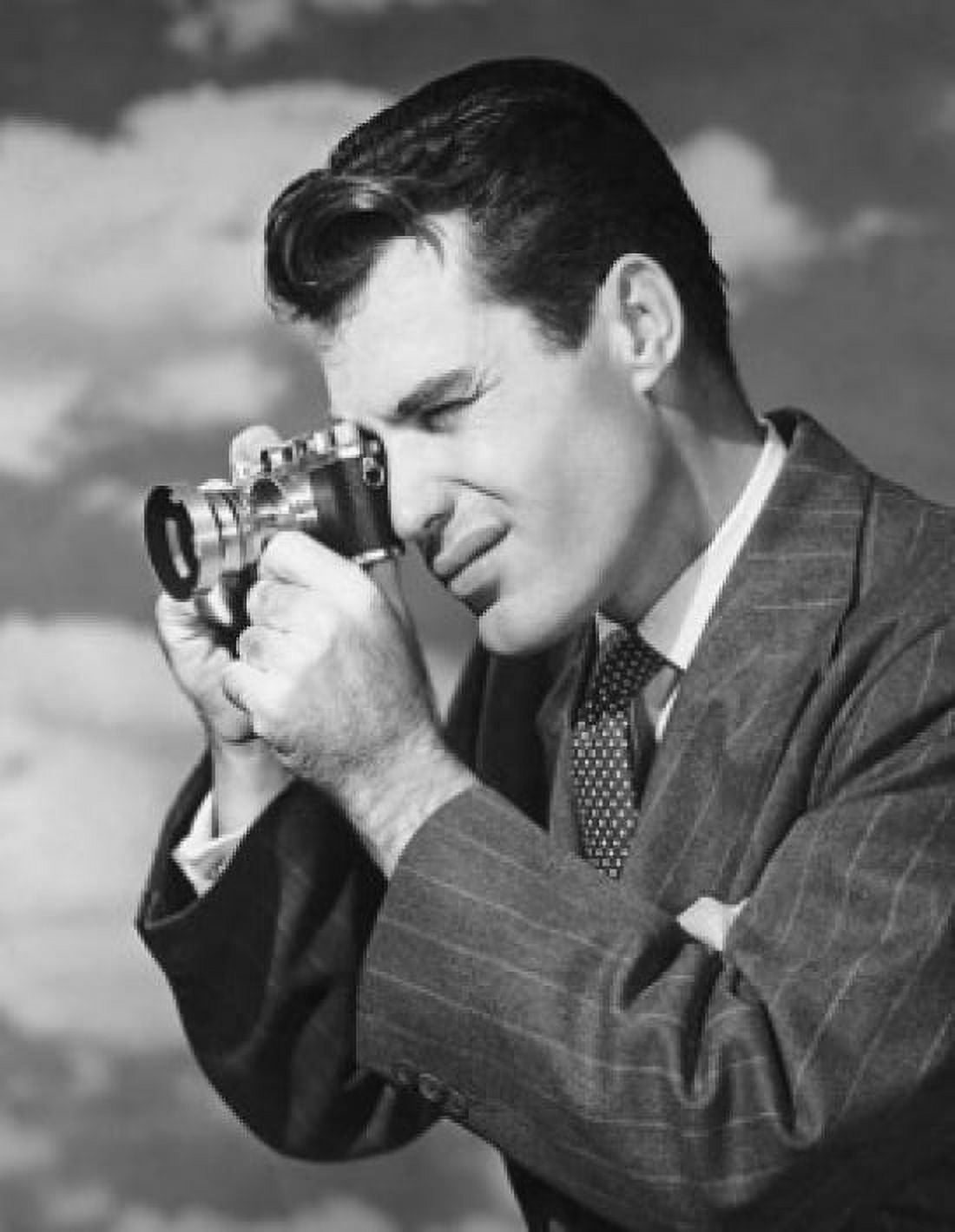 Posterazzi Side profile of a young man taking a photograph Canvas Art - (24 x 36)