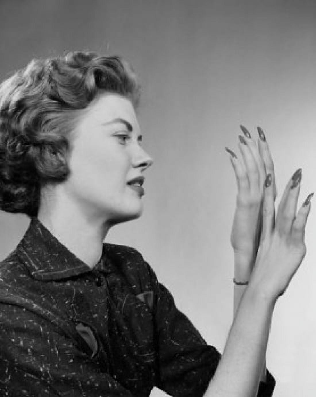 Posterazzi Side profile of a young woman looking at her fingernails Canvas Art -  (24 x 36)