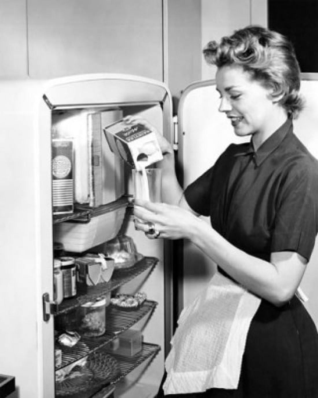 Posterazzi Side profile of a young woman pouring milk into a glass from a milk carton Canvas Art - (24 x 36)