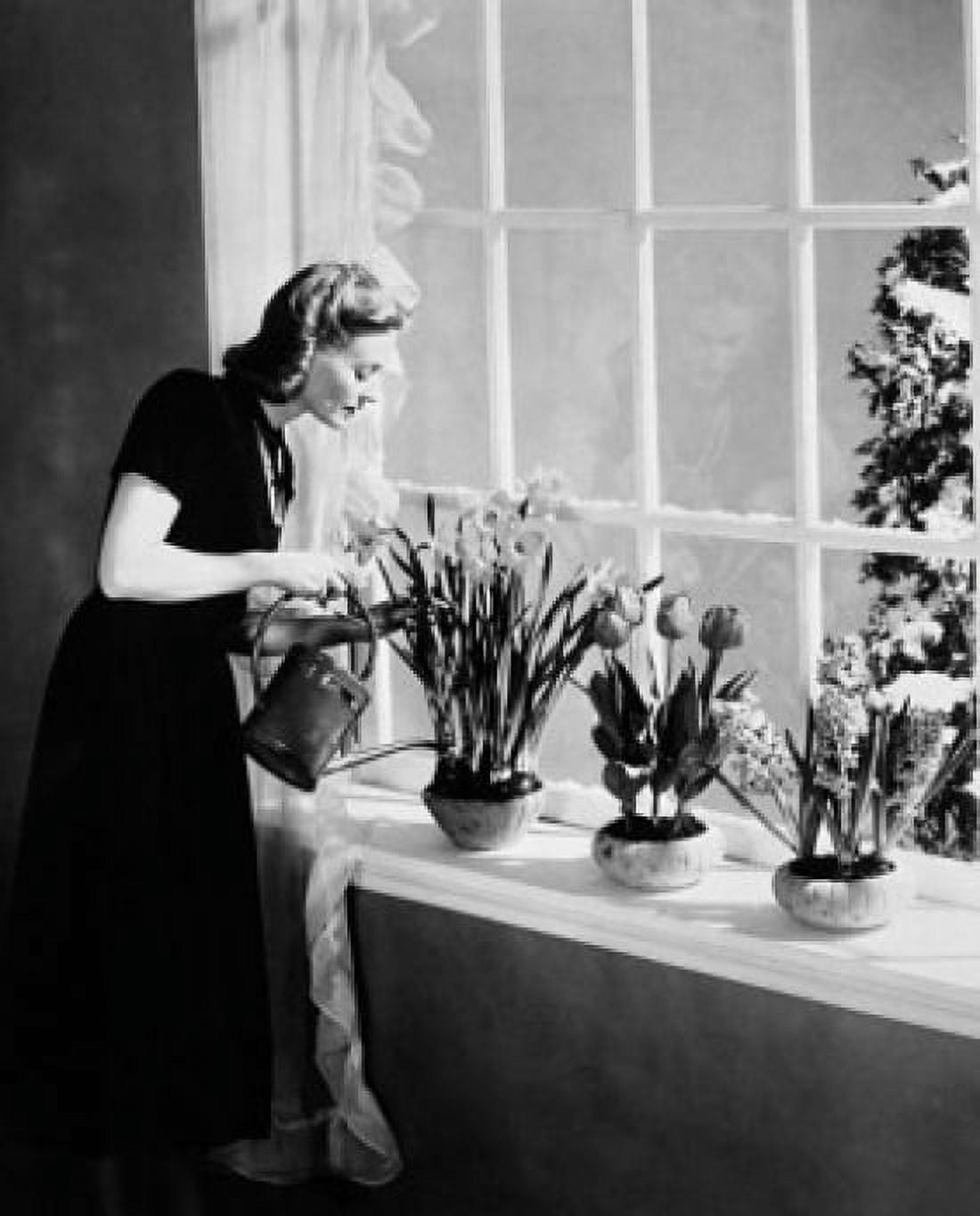 Posterazzi Side profile of a young woman watering plants Canvas Art - (24 x 36)