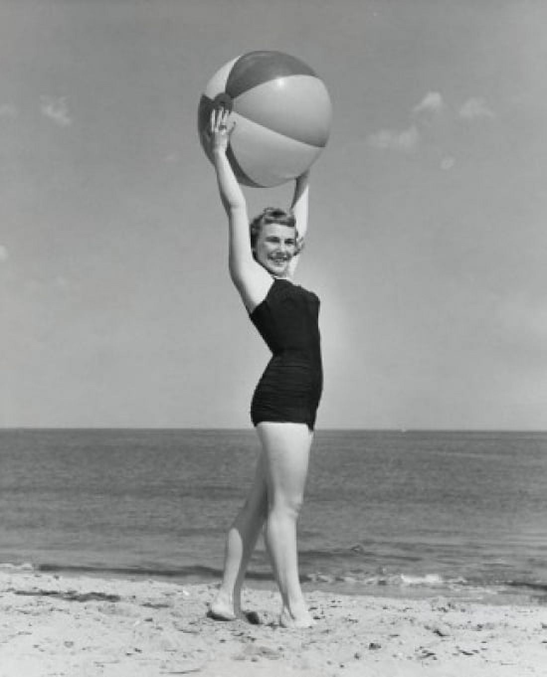 Posterazzi Side profile of young woman holding beach ball on beach Canvas Art - (24 x 36)