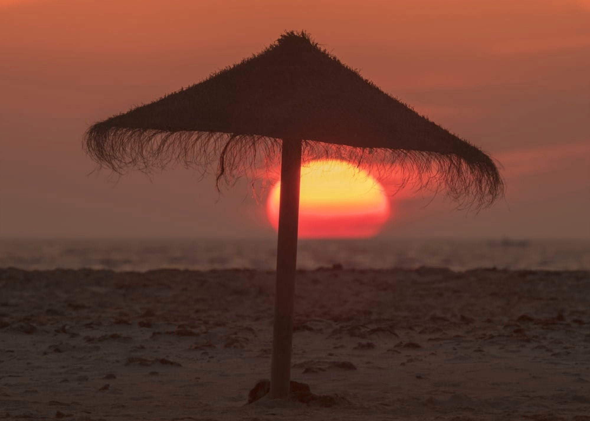 Posterazzi Silhouette of a beach umbrella on the beach with a colourful sun sinking into the horizon over the ocean Tarifa Cadiz Andalusia Spain Canvas Art - Ben Welsh Design Pics (36 x 26)