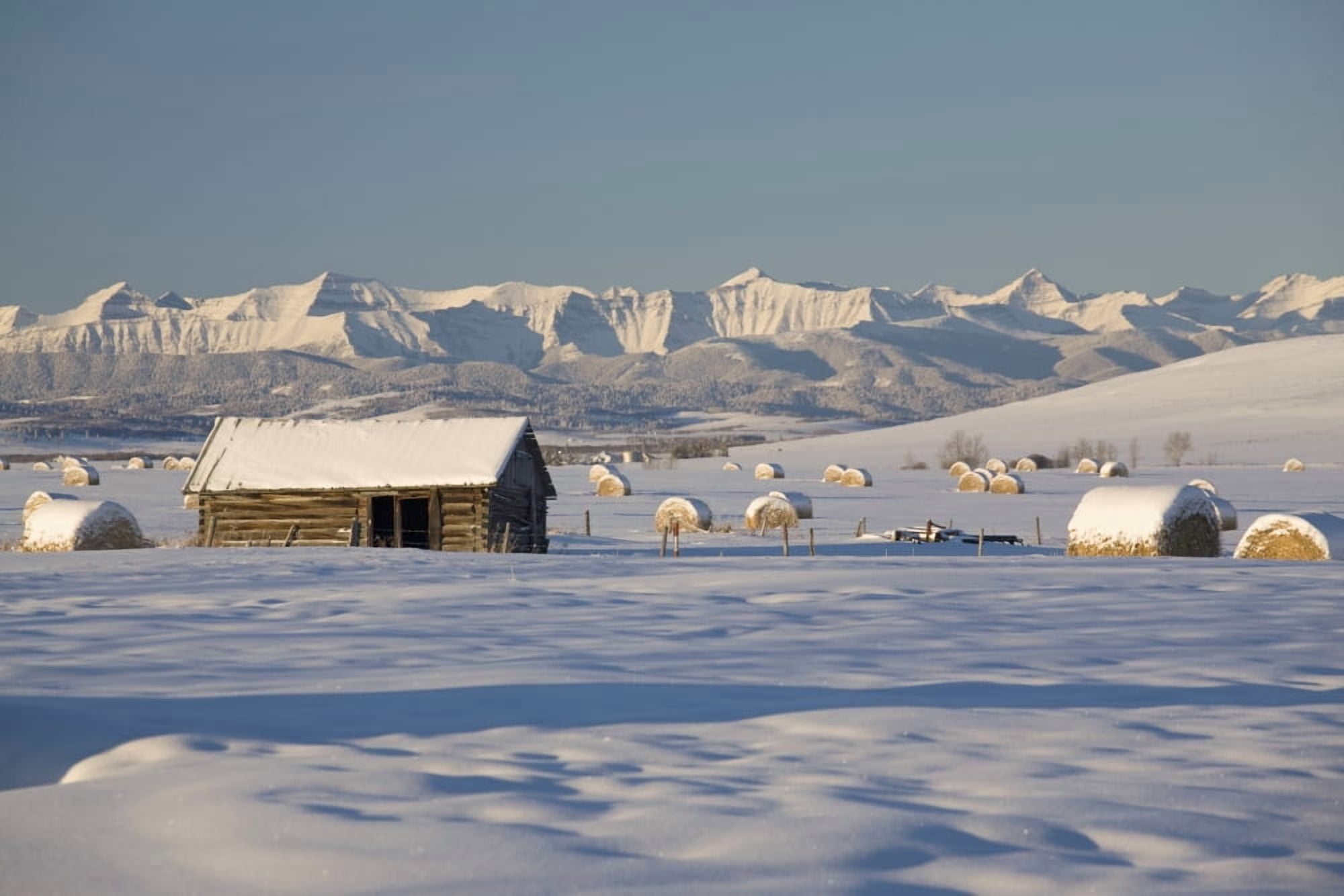 Posterazzi Snow Covered Log Cabin And Hay Bales In A Field With Snow Covered Mountains Okotoks Alberta Canada Canvas Art - Michael Interisano Design Pics (38 x 24)