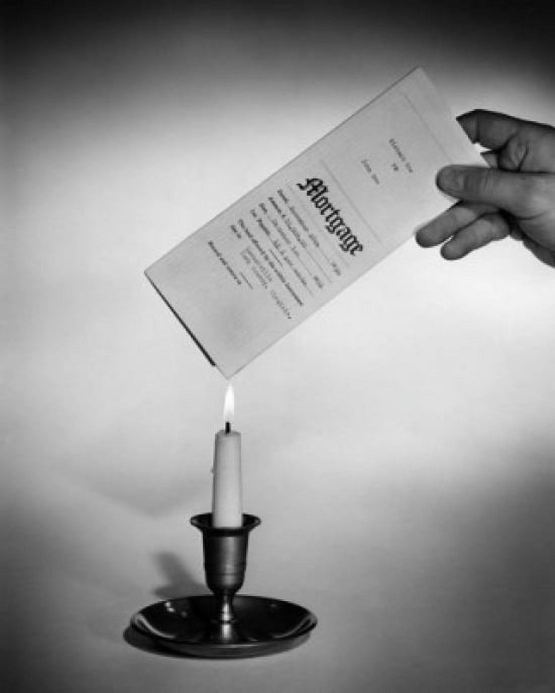 Posterazzi Studio shot of hand holding mortgage document over candle flame Canvas Art - (24 x 36)