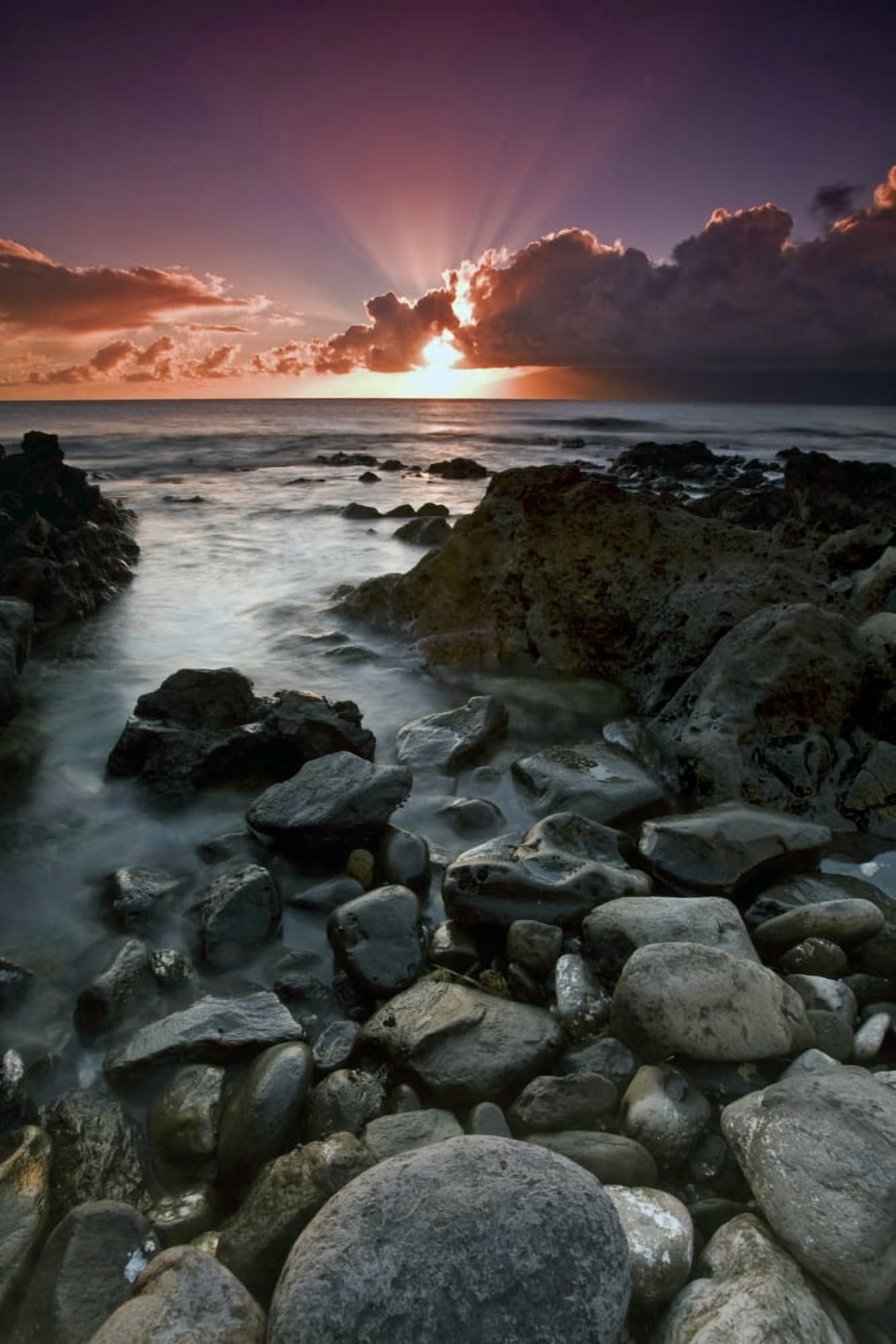 Posterazzi Sun rays shine above the clouds as the sun sets over the ocean with rocks along the coast in the foreground Hawaii United States of America Canvas Art - Scott Mead  Design Pics (24 x 38)