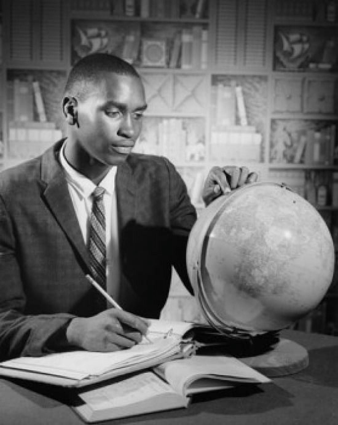 Posterazzi Teenage boy studying a globe Canvas Art - (24 x 36)