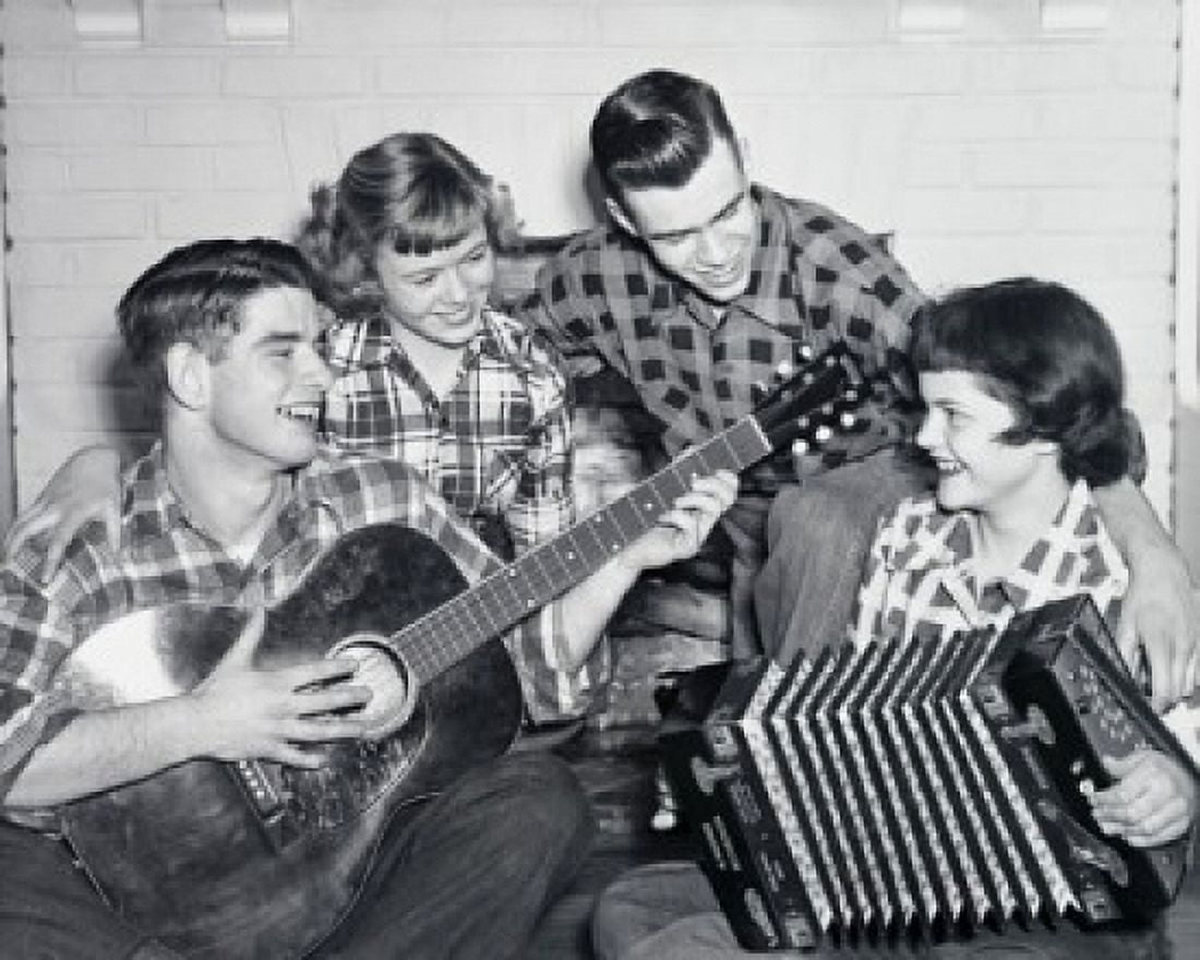 Posterazzi Teenage couple playing musical instruments with another teenage couple looking at them Canvas Art - (24 x 36)