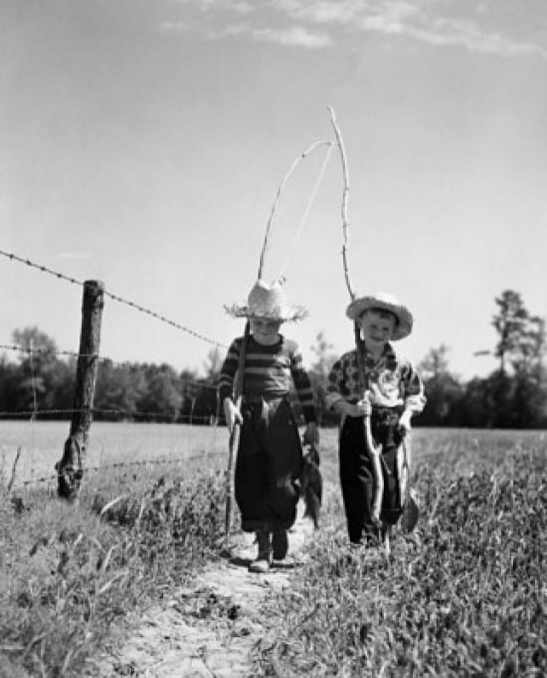 Posterazzi Two boys carrying fishing rods and walking in a field Canvas Art - (24 x 36)