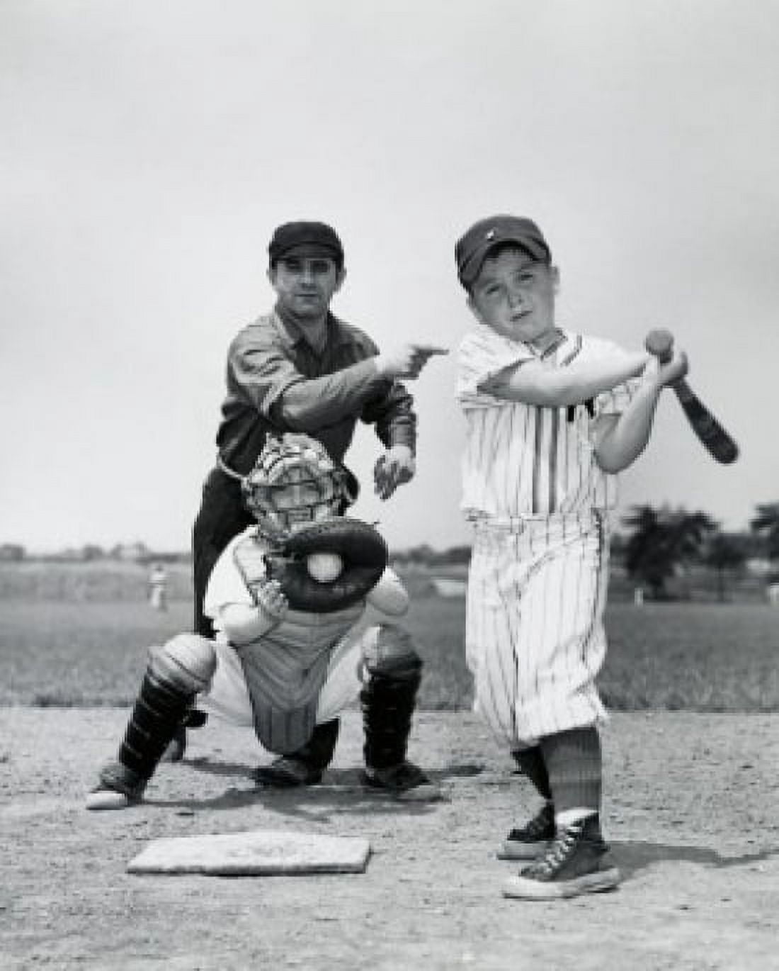 Posterazzi Two boys playing baseball with a baseball umpire standing behind them Canvas Art - (24 x 36)
