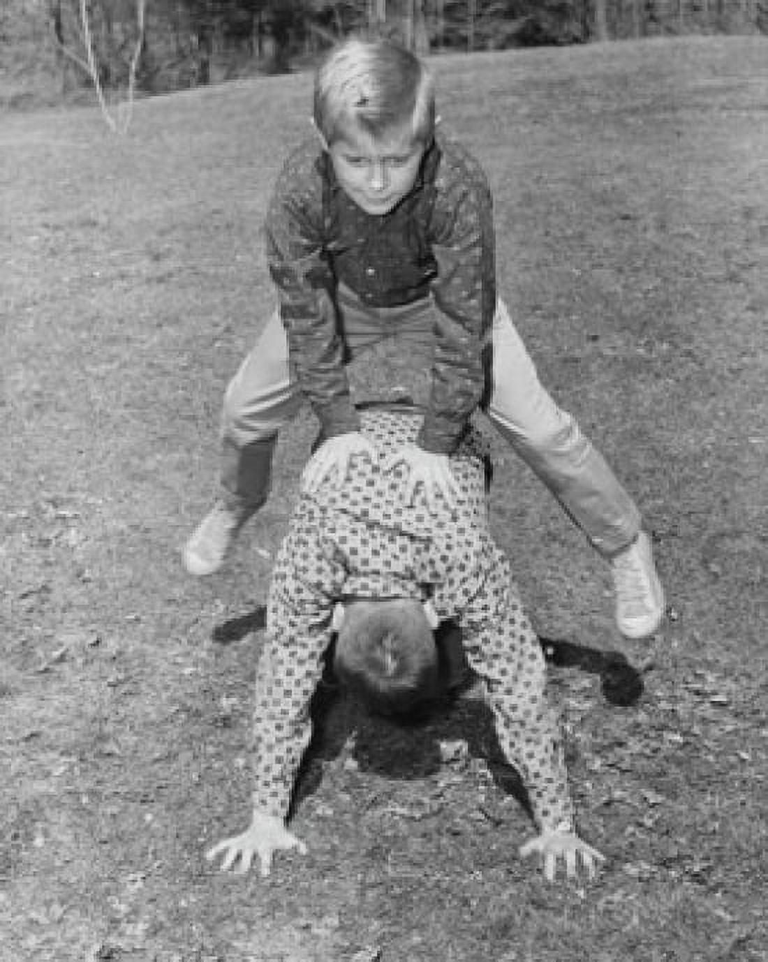 Posterazzi Two boys playing leapfrog in a park Canvas Art - (24 x 36)