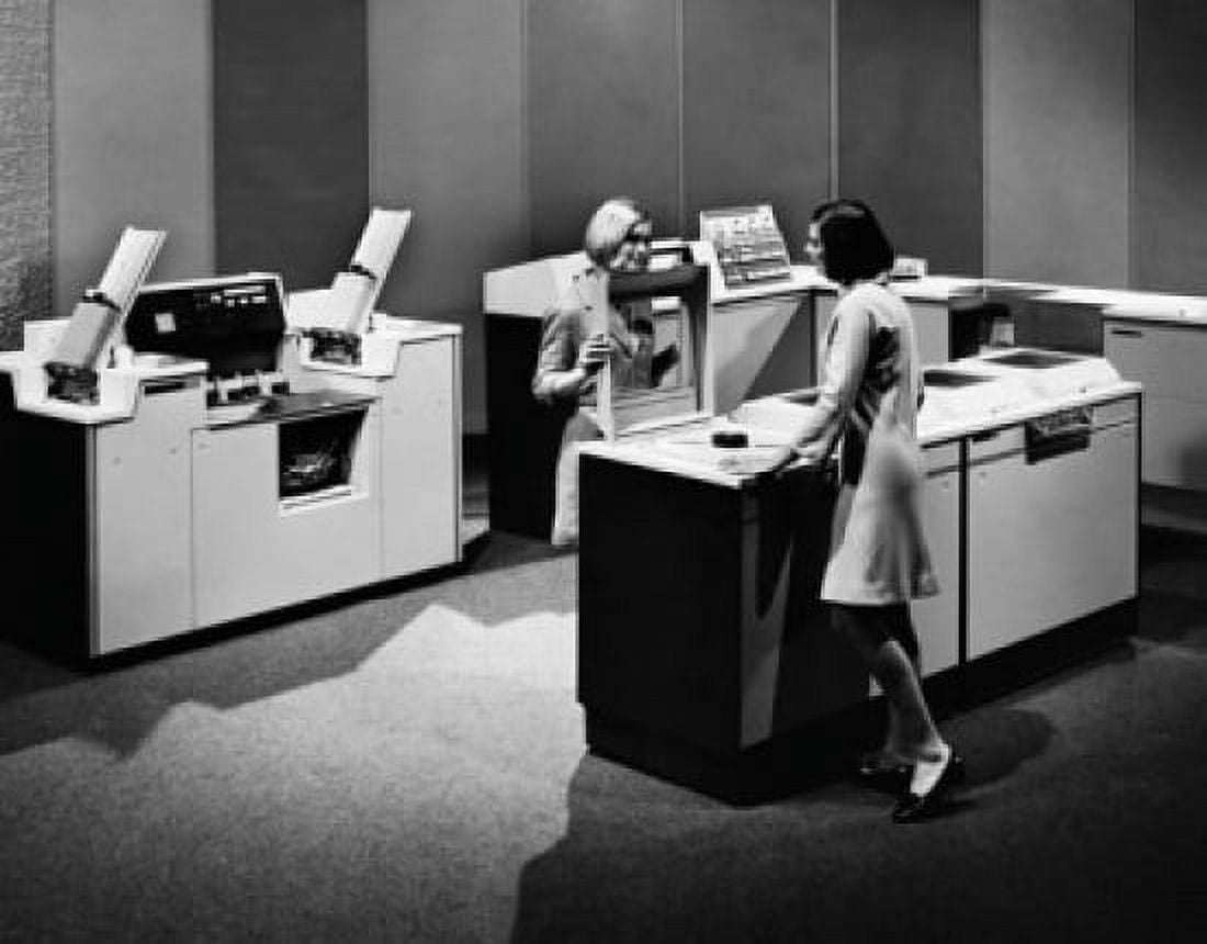 Posterazzi Two businesswomen standing near a mainframe computer Canvas Art - (24 x 36)