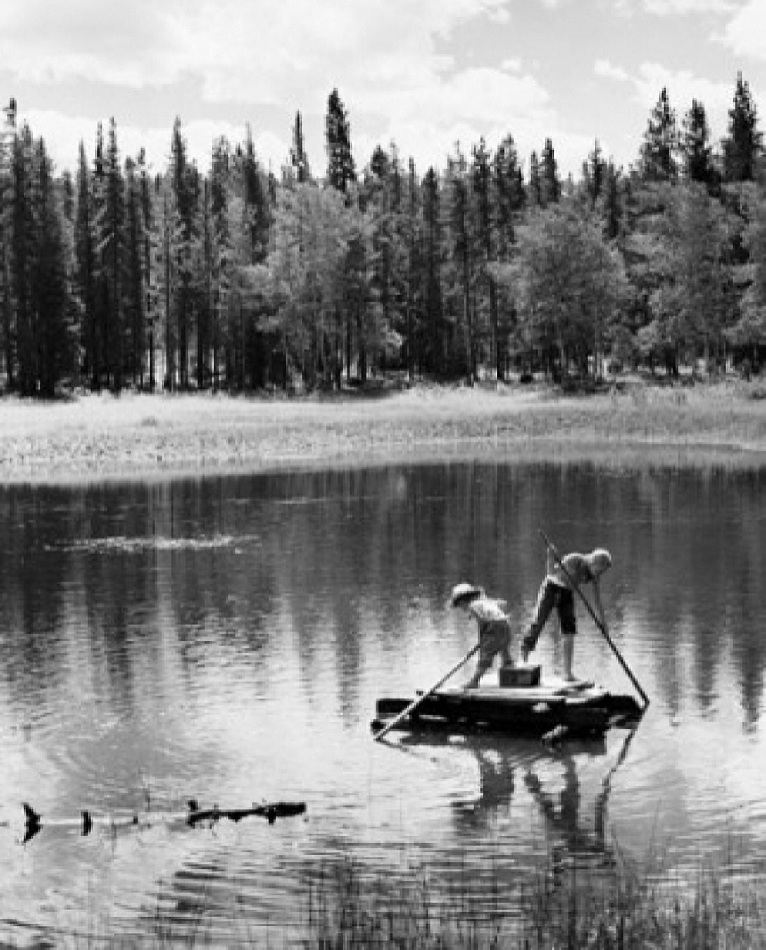 Posterazzi Two children rowing a wooden raft Canvas Art - (24 x 36)
