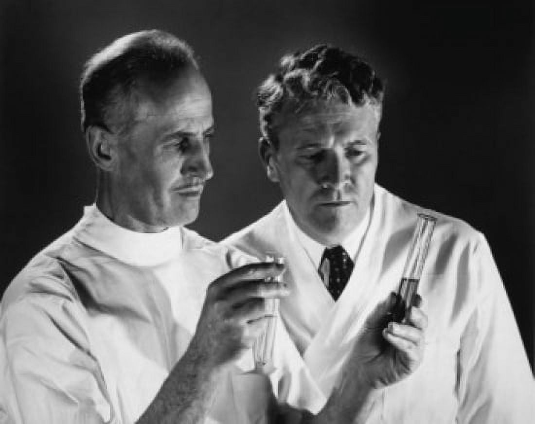 Posterazzi Two scientists analyzing chemicals in two test tubes Canvas Art - (24 x 36)