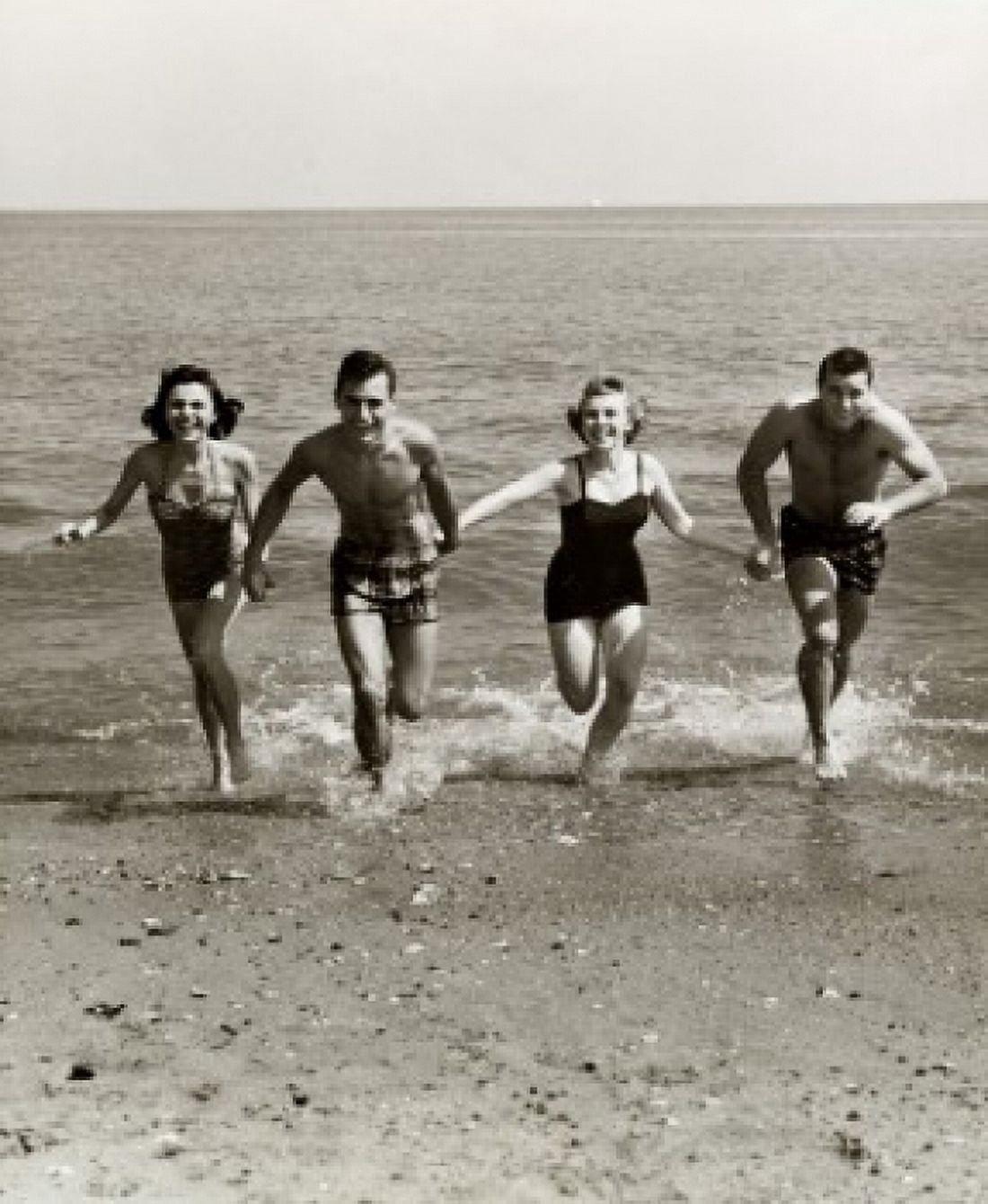 Posterazzi Two young couples running on the beach Canvas Art - (24 x 36)