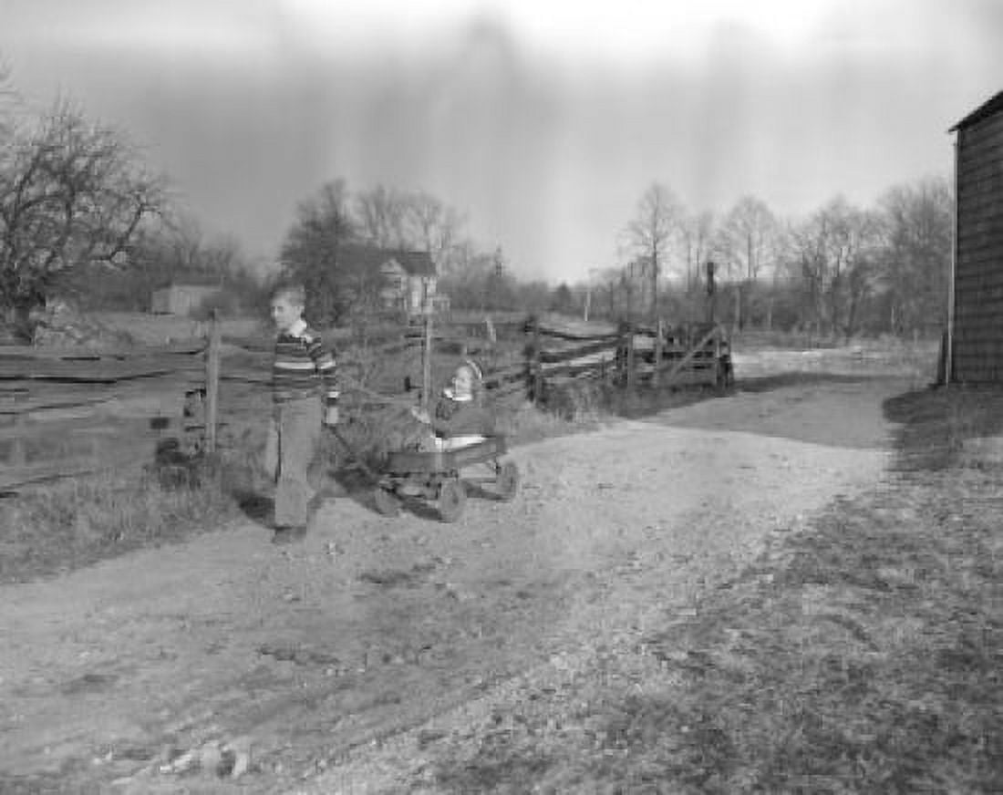 Posterazzi Vintage photograph of boy pulling gocart with girl on country road Canvas Art -  (24 x 36)