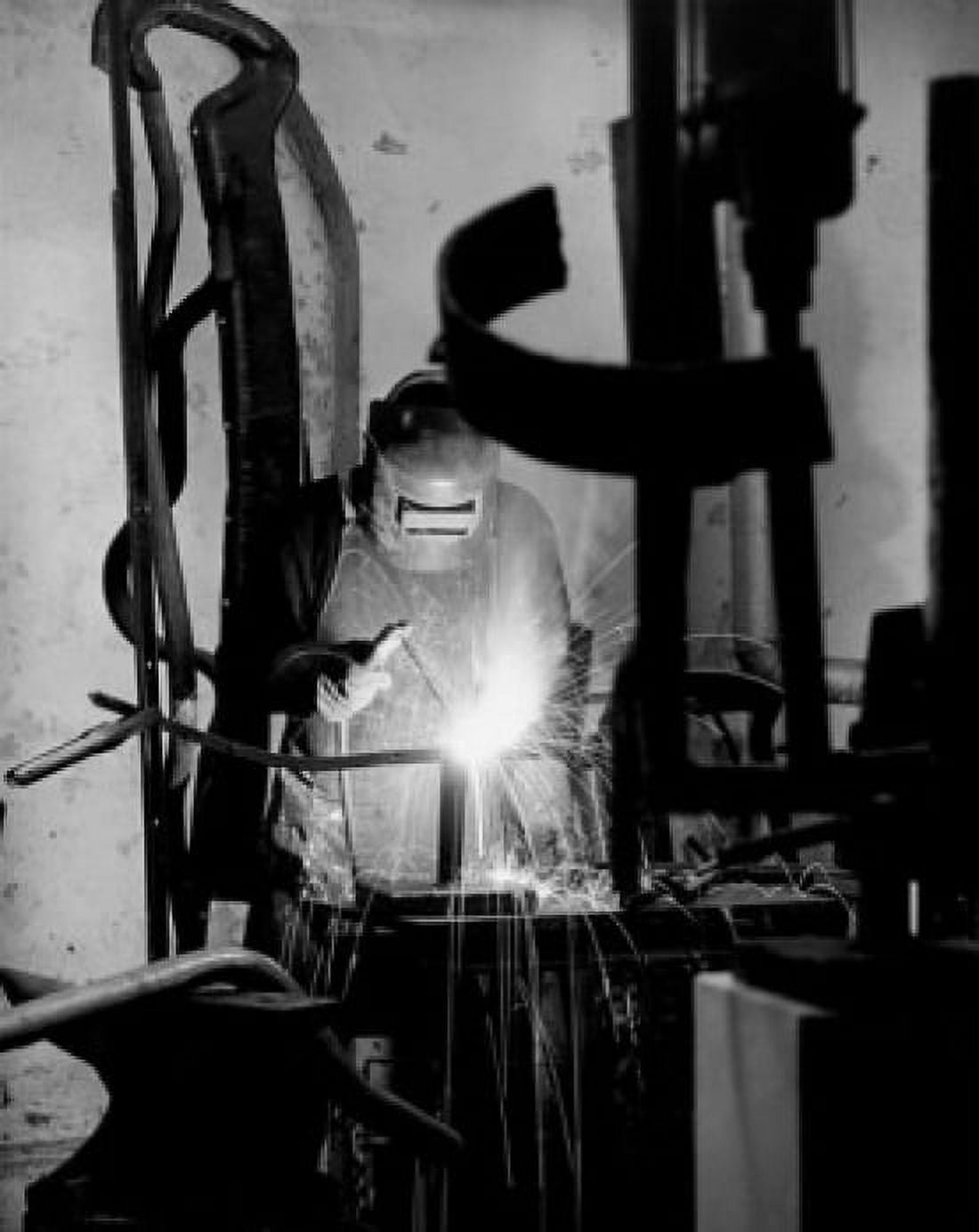 Posterazzi Welder welding in a factory Canvas Art - (24 x 36)