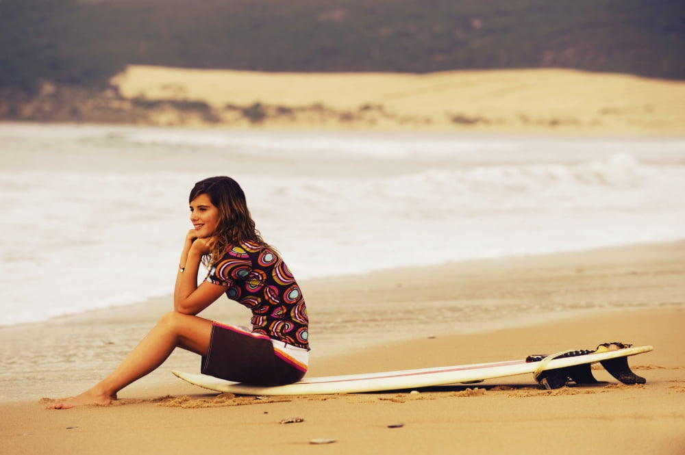 Posterazzi Young Woman Sitting On Her Surf Board On The Beach Tarifa Cadiz Andalusia Spain Canvas Art - Ben Welsh Design Pics (38 x 24)