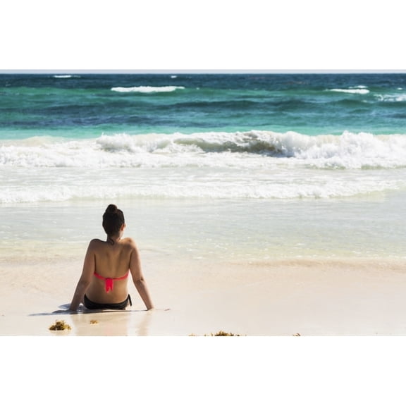 Posterazzi DPI12269299 Young Woman Sitting on Sandy Beach in Water Looking Out at Waves Coming in & Poster Print - 19 x 12 in.