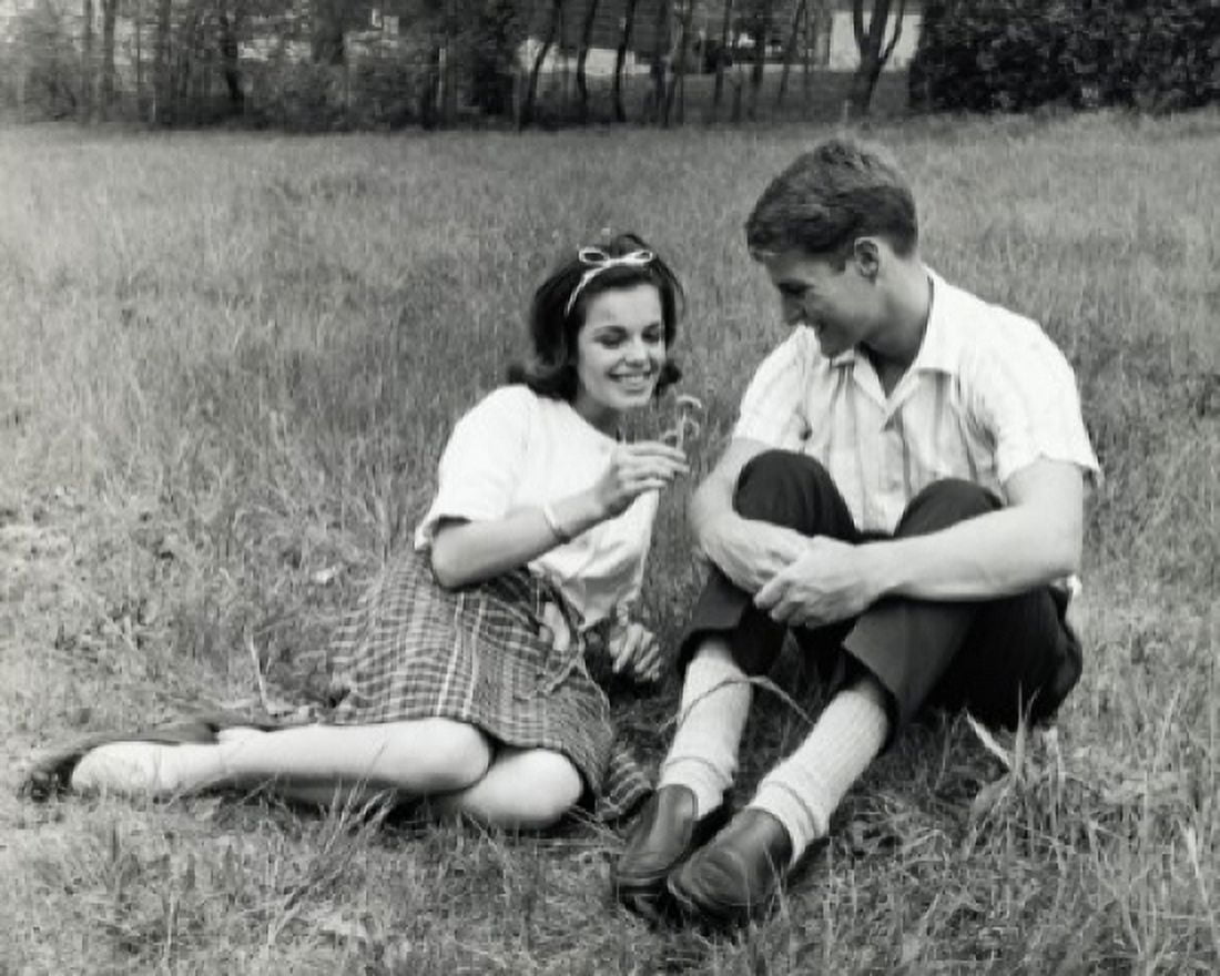 Posterazzi Young couple sitting in a park smiling Canvas Art - (24 x 36)
