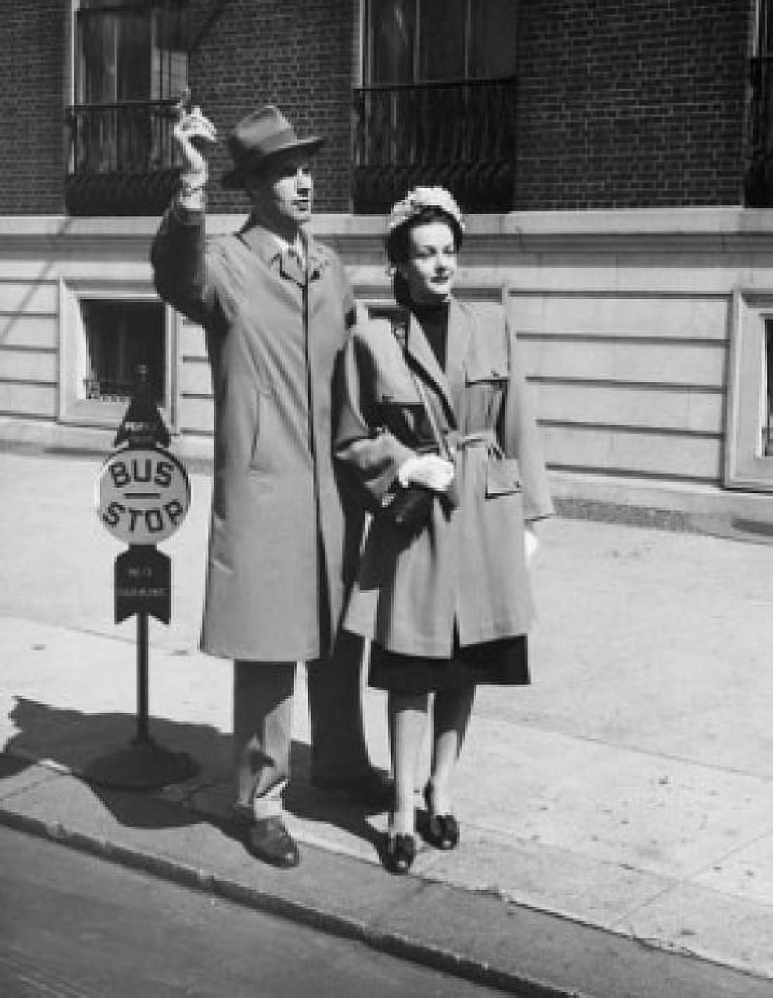 Posterazzi Young man and a young woman waiting at a bus stop Canvas Art - (24 x 36)