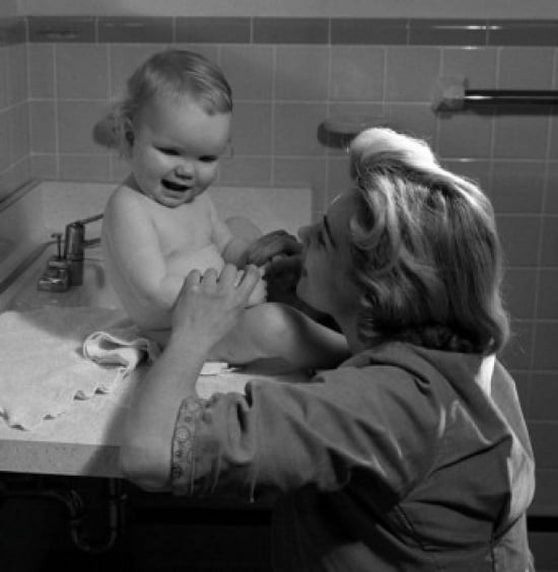 Posterazzi Young woman and baby girl sitting on bathroom sink Canvas Art - (24 x 36)