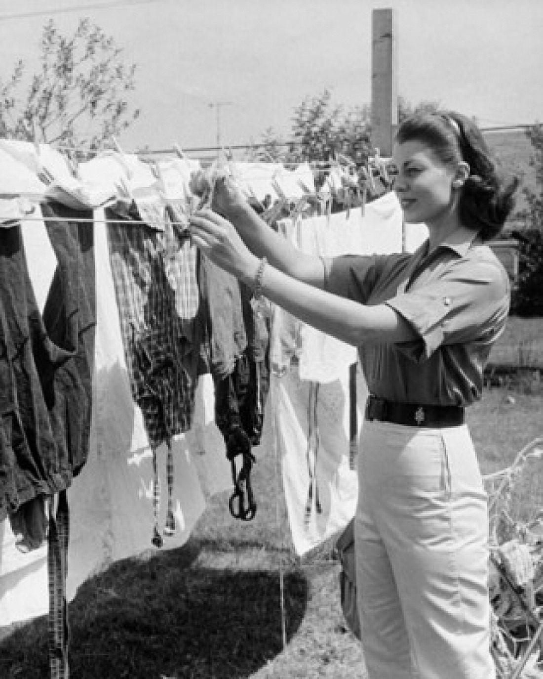 Posterazzi Young woman hanging clothes on a clothesline Canvas Art - (24 x 36)